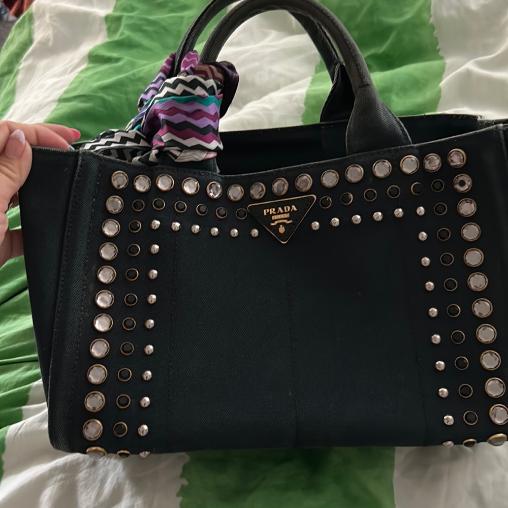 Prada canopy jean material medium size tote style purse wear on handle